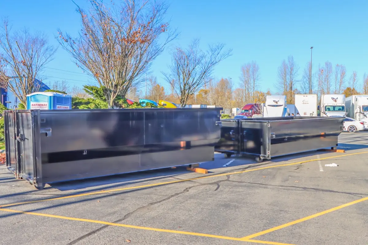 Professional dumpster rental service with roll-off container on residential driveway in Medway
